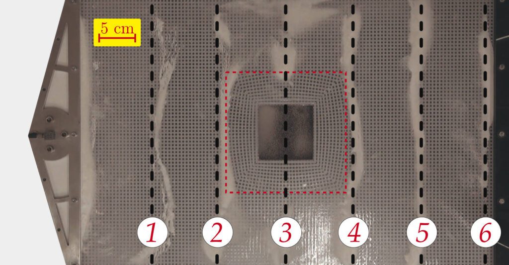 Cymatics for the cloaking of flexural vibrations in a structured plate